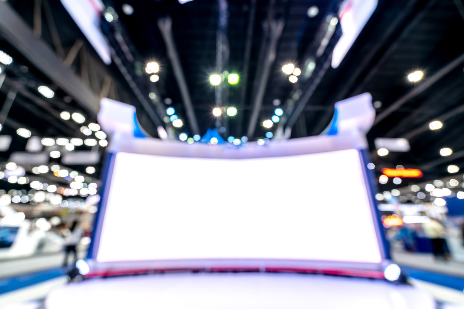 Abstract blurred defocused tradeshow event exhibition, business convention show, job fair, technology expo. White big screen trade fair event. Marketing advertisement concept.